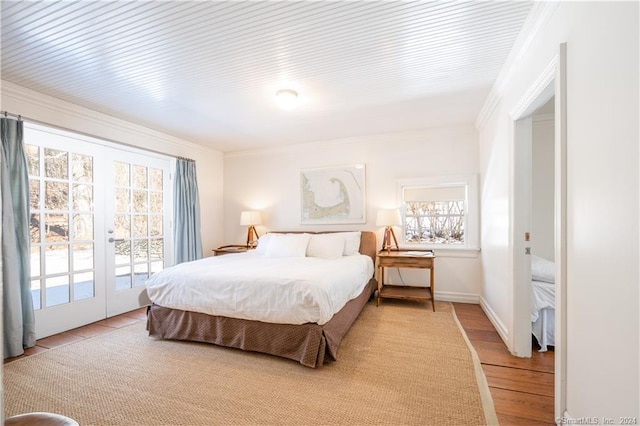 bedroom featuring french doors, ornamental molding, light hardwood / wood-style floors, and access to exterior