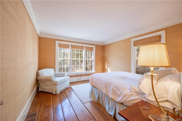 bedroom featuring hardwood / wood-style floors and ornamental molding