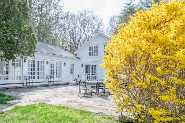 back of property with french doors and a patio area