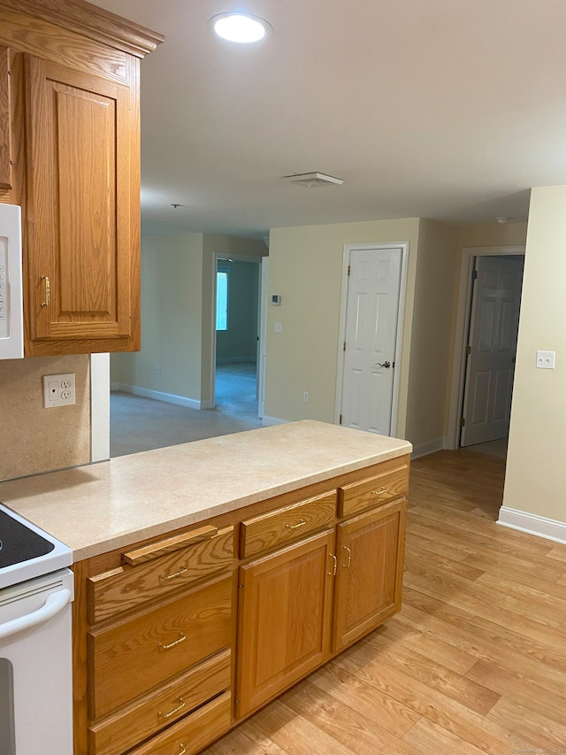 kitchen featuring light wood-type flooring and electric stove