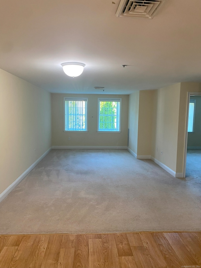 empty room with light hardwood / wood-style flooring