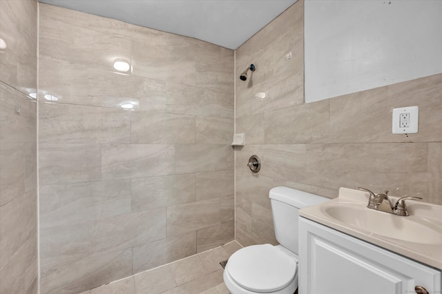 bathroom featuring tile walls, vanity, toilet, and tile patterned flooring