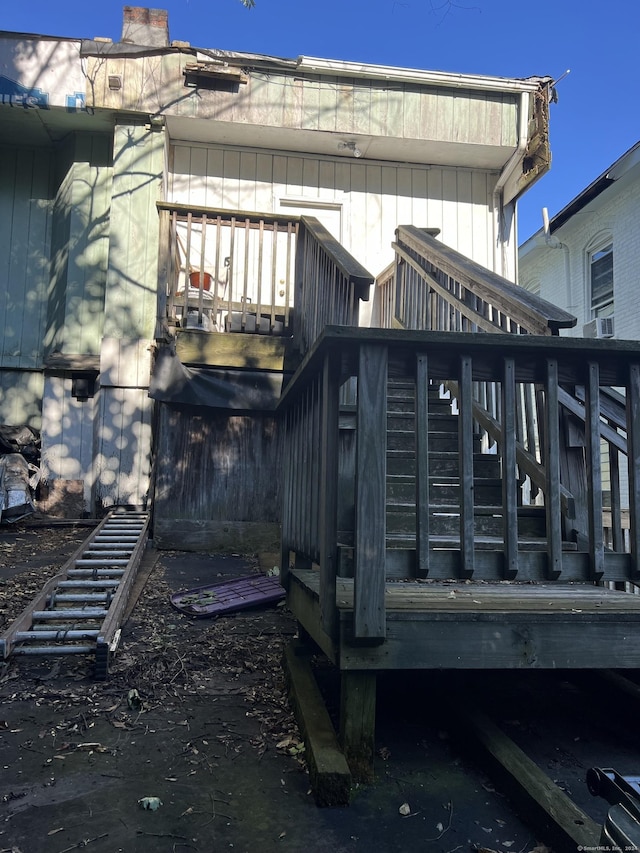 rear view of house with stairway and a deck