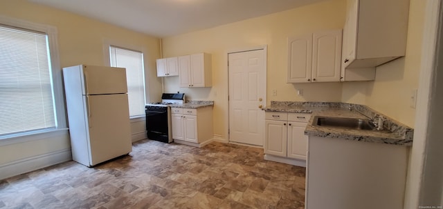 kitchen with white cabinetry, light stone counters, sink, white refrigerator, and black range with gas stovetop