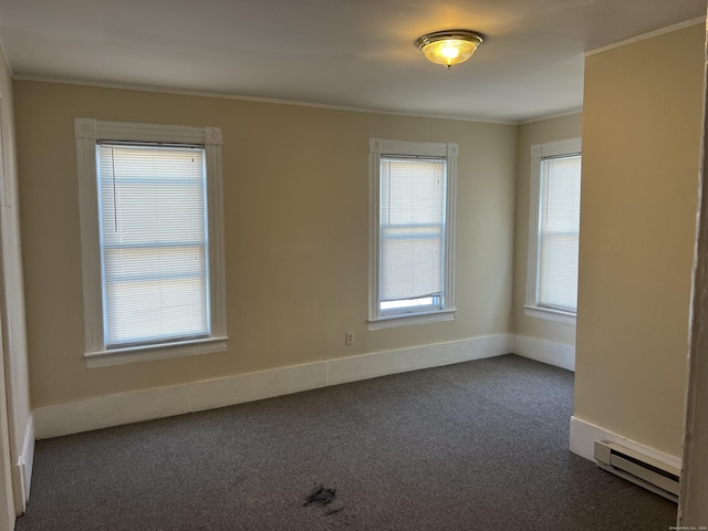 unfurnished room featuring a wealth of natural light, carpet flooring, baseboard heating, and ornamental molding