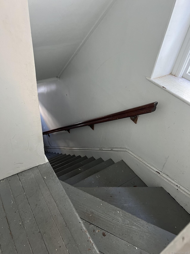 stairs featuring hardwood / wood-style floors