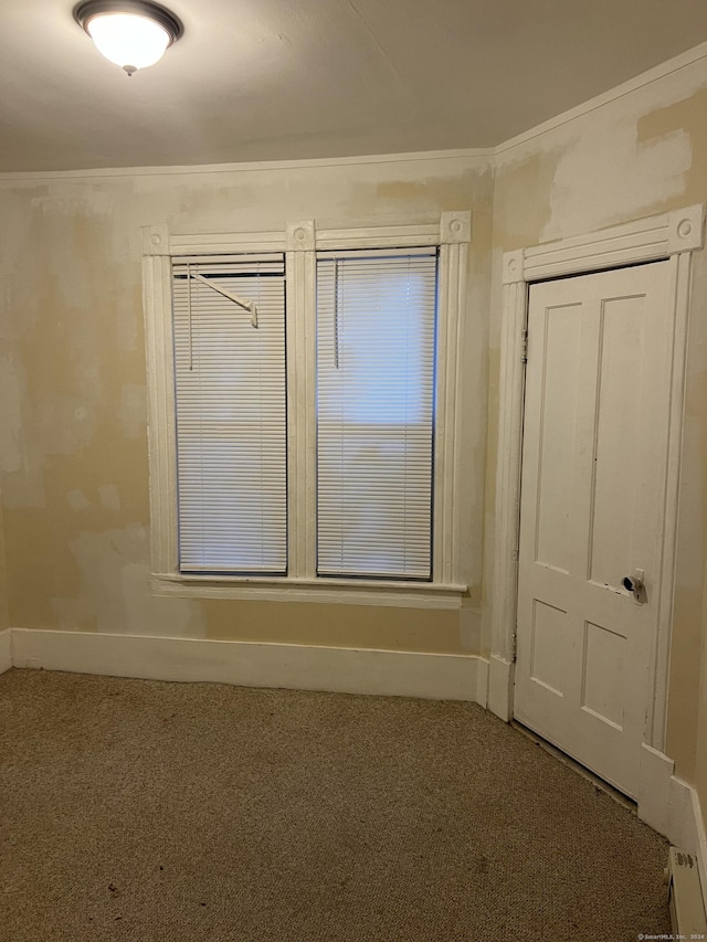 unfurnished room with carpet and baseboards