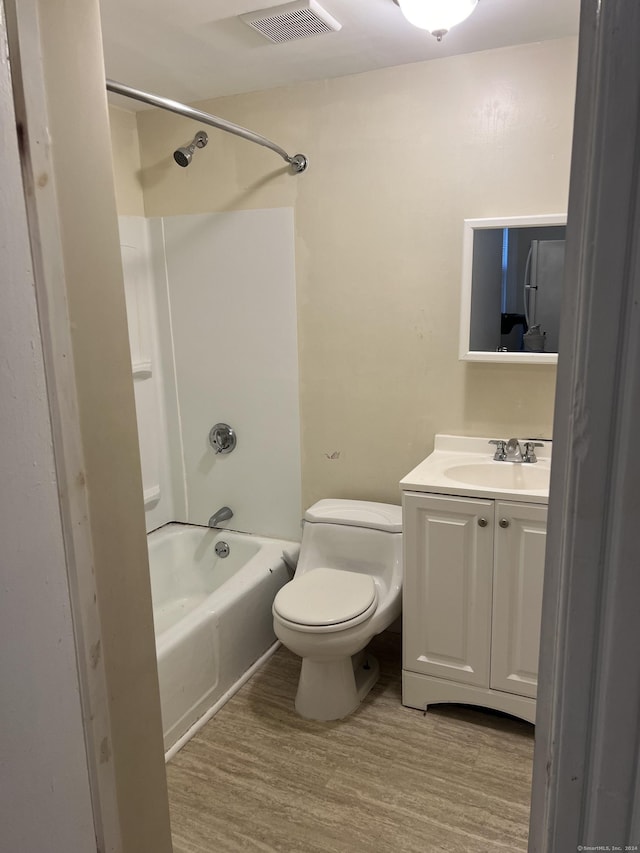 bathroom with visible vents, bathtub / shower combination, wood finished floors, and vanity