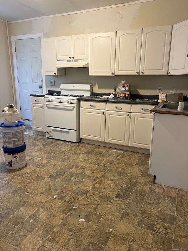 kitchen with crown molding, sink, white range with gas cooktop, and white cabinets