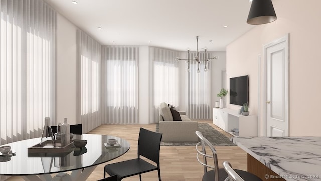 dining room featuring a notable chandelier and light hardwood / wood-style flooring