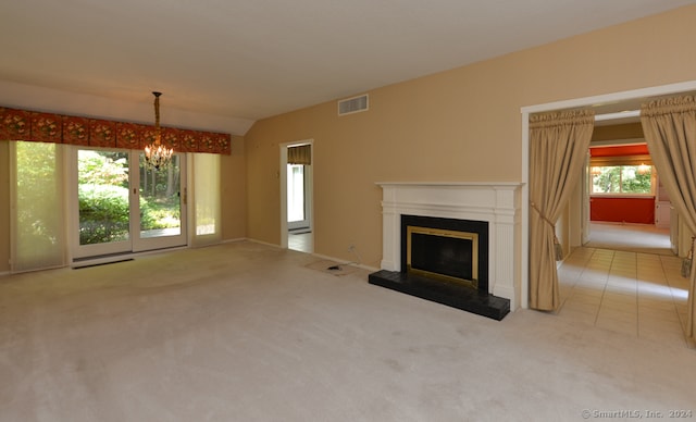 unfurnished living room with lofted ceiling, a notable chandelier, and light carpet