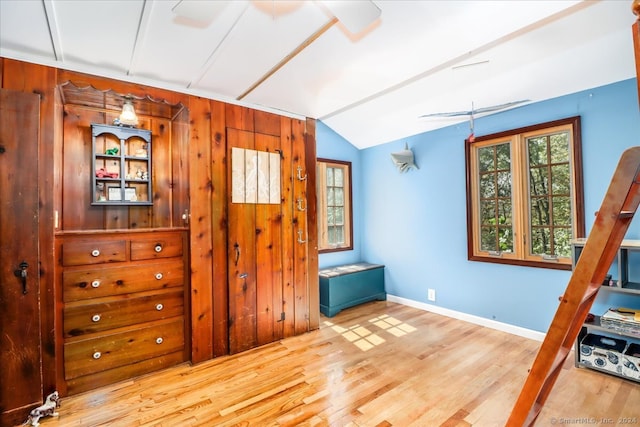 interior space with lofted ceiling and light hardwood / wood-style flooring