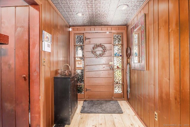 interior space with wood-type flooring and wooden walls