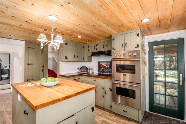 kitchen featuring hanging light fixtures, stainless steel double oven, wooden ceiling, light hardwood / wood-style flooring, and butcher block counters