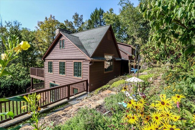 view of side of property featuring a wooden deck