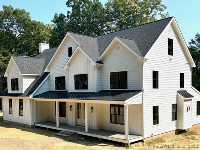 modern farmhouse style home featuring covered porch