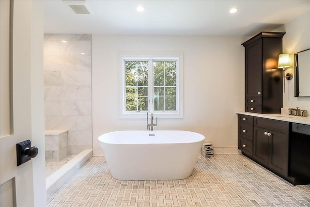 bathroom with vanity and independent shower and bath