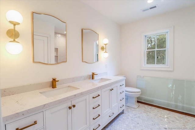 bathroom featuring vanity and toilet