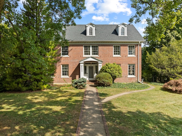 colonial-style house with a front lawn