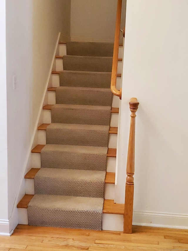 stairs with hardwood / wood-style floors