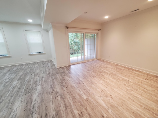 unfurnished room featuring crown molding and light hardwood / wood-style flooring