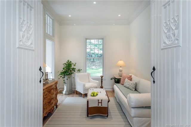 living room with light hardwood / wood-style floors and ornamental molding