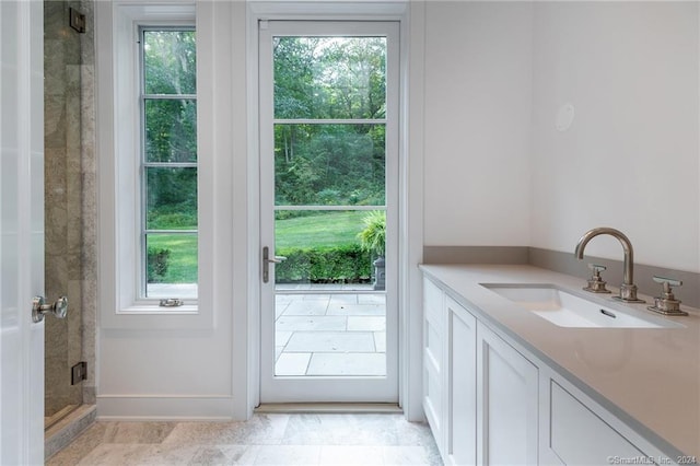 bathroom with a shower with door and vanity