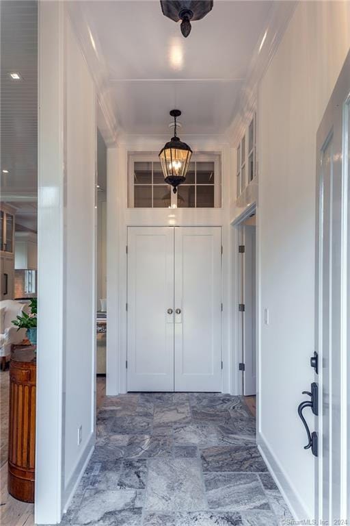 foyer entrance featuring ornamental molding