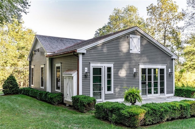 back of house with a lawn and a patio area