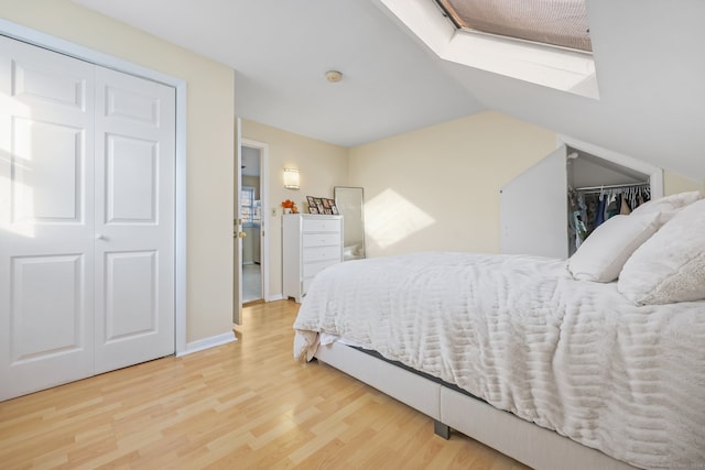 bedroom featuring hardwood / wood-style flooring and vaulted ceiling