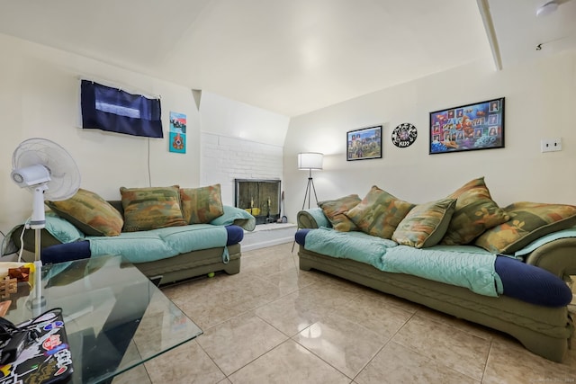 living room with light tile patterned floors and a brick fireplace