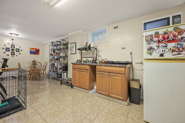 kitchen featuring light tile patterned flooring and white refrigerator