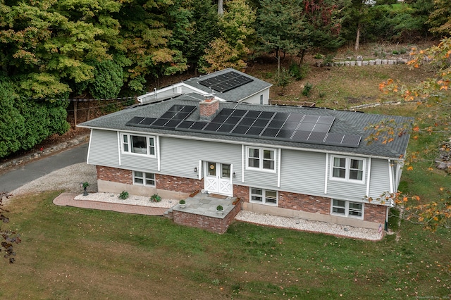 exterior space featuring solar panels and a yard