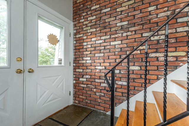 doorway featuring brick wall