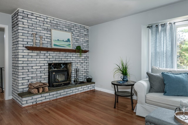 living room featuring dark wood-type flooring and a wood stove