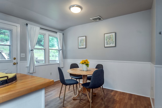 dining room with a wealth of natural light and wood-type flooring