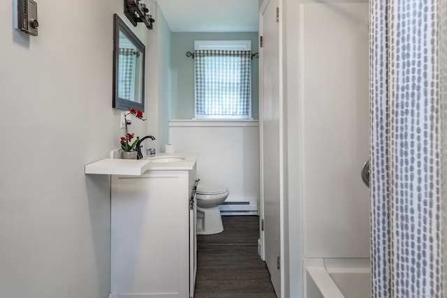 bathroom featuring baseboard heating, wood-type flooring, vanity, and toilet