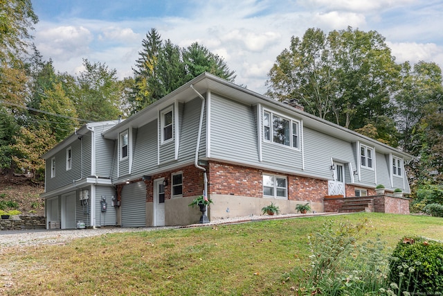 split foyer home with a front lawn and a garage