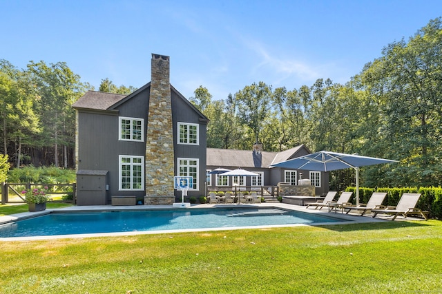 view of swimming pool featuring a lawn and a patio