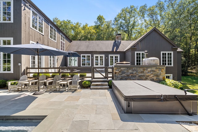 exterior space featuring a covered hot tub