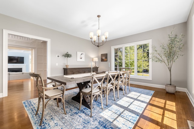 dining area featuring an inviting chandelier and dark hardwood / wood-style flooring