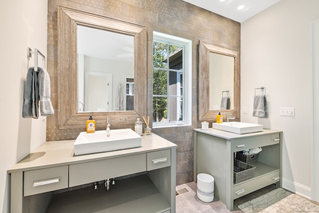 bathroom with vanity and tile walls