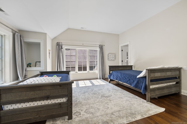 bedroom featuring lofted ceiling and dark hardwood / wood-style floors