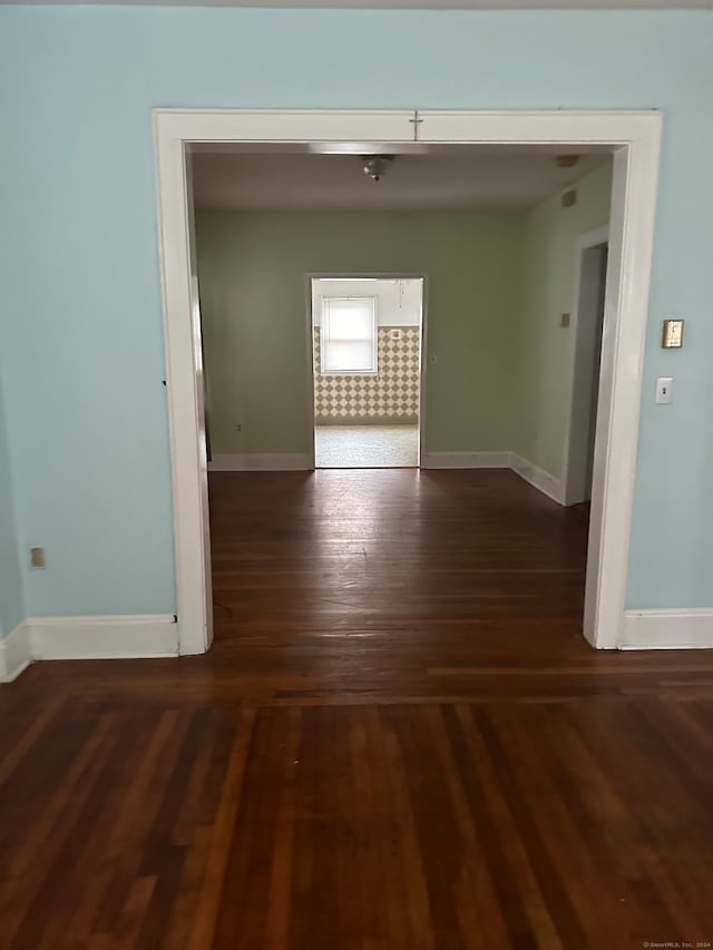 spare room with dark hardwood / wood-style floors