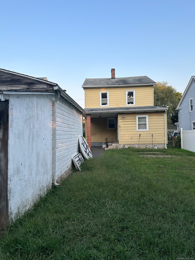 back of property featuring a lawn