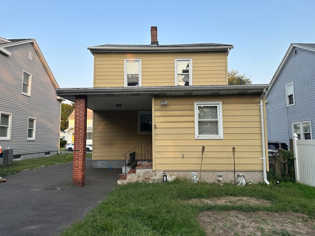 rear view of property with a carport