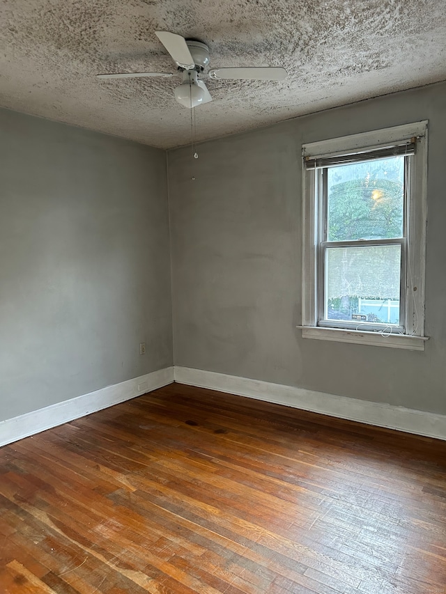 unfurnished room featuring ceiling fan, wood-type flooring, and a textured ceiling