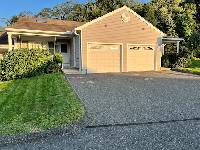 ranch-style house featuring a garage and a front lawn