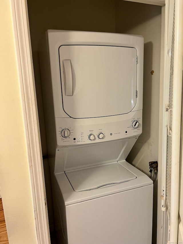 laundry room with stacked washing maching and dryer