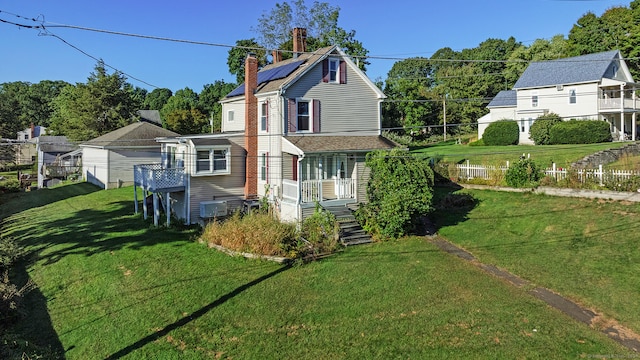 rear view of property with a yard